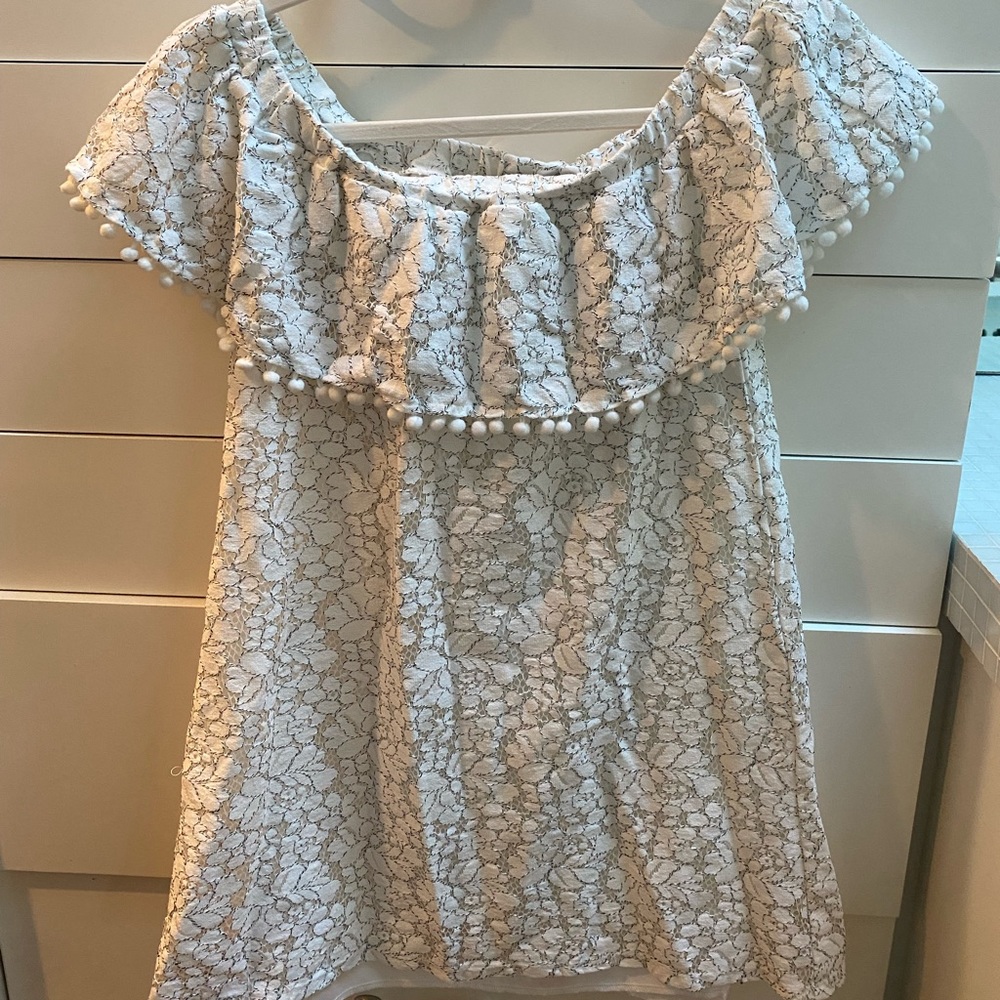 Off the shoulder white dress with delicate lace detail & Pom Pom trim.